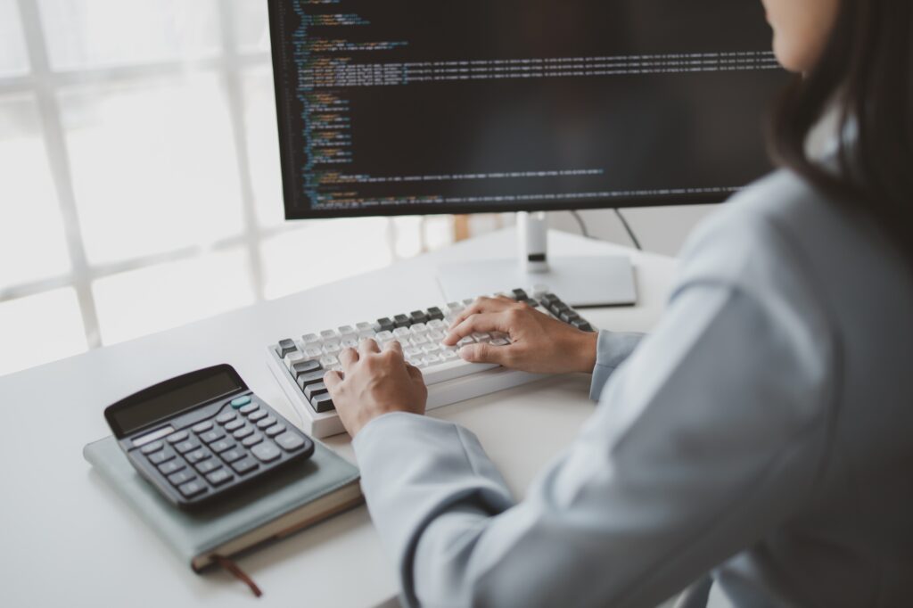 Female programmer typing on computer keyboard, programmer designing custom computer programming, cod