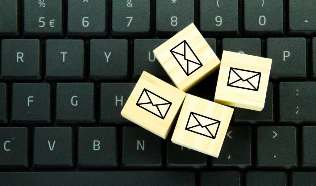 wooden cube with email icon.